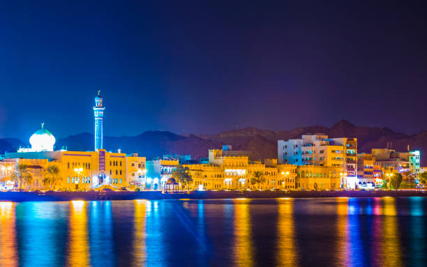 vista notturna del porto di muttrah, muscat, oman. - passenger ship ferry crane harbor foto e immagini stock