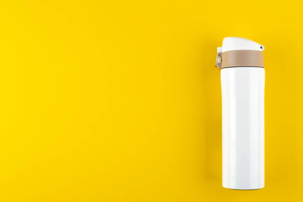 istock white thermos for walking on a bright yellow background 1140977917