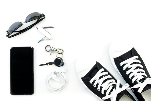 sneaker and mobile phone and travel accessories isolated on white background