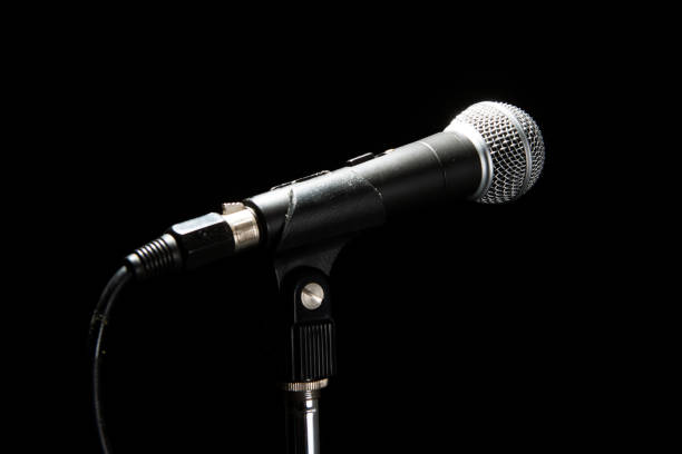 istock Black classic microphone on black dark background. Music and concert concept. 1140979115