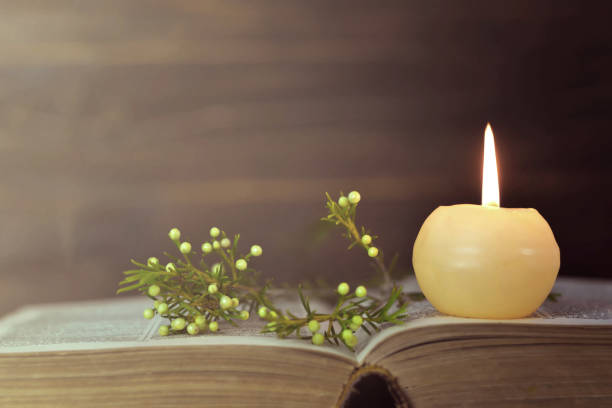 istock Candle, book and flowers 1140980317
