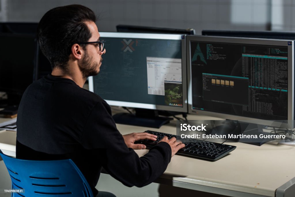 Young Computer Science Student Developing With His Computer On A Linux ...