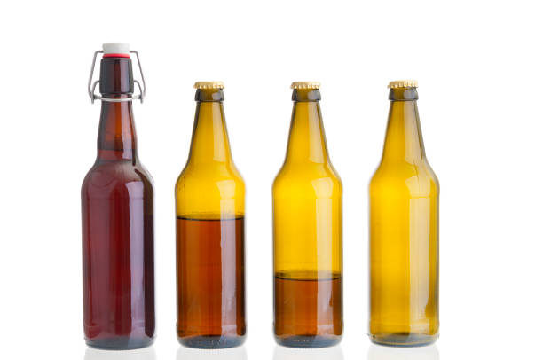 istock Row of beer bottles isolated on white background 1140981686