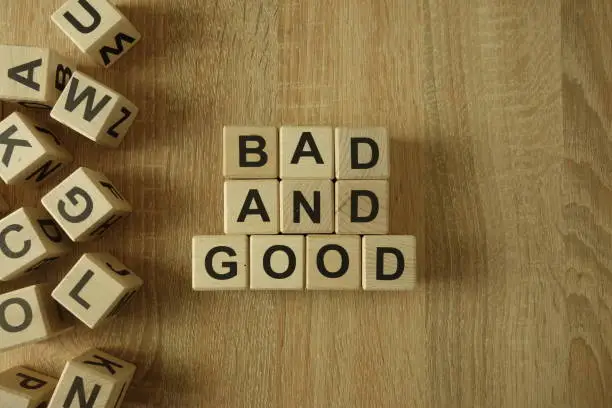 Photo of Bad and good text from wooden blocks