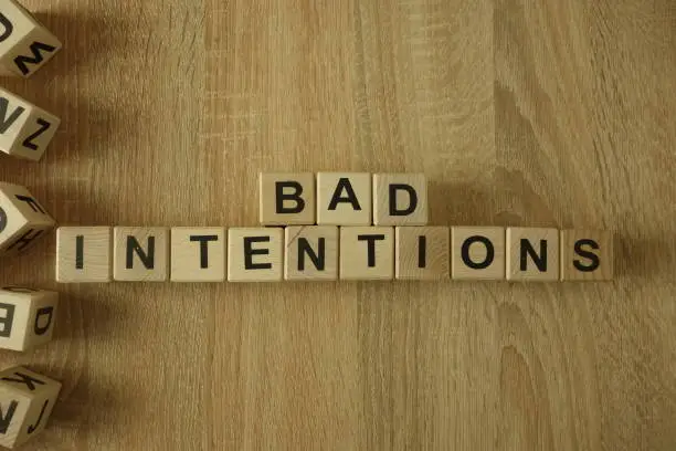 Photo of Bad intentions text from wooden blocks