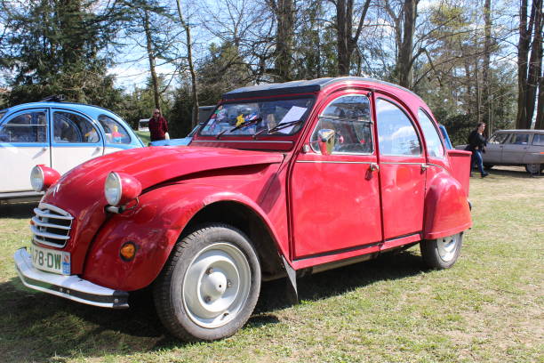 red classic convertible car citroën 2cv in citroën 2cv exhibition in sathonay village in april 2018 - citroën 2cv stockfoto's en -beelden