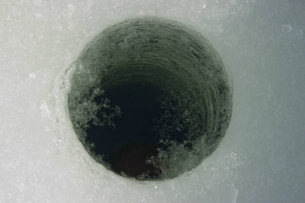 istock drilled a hole in the ice 1140986229
