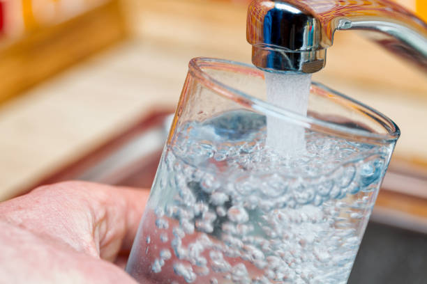 istock Filling up a glass with drinking water from kitchen tap 1140986765