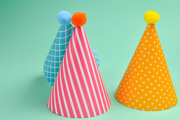 istock Colorful birthday cap on a green background. 1140987634