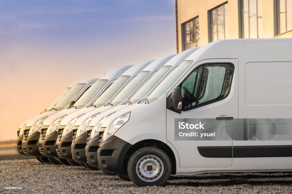 commercial delivery vans in row commercial delivery vans parked in row. Transporting service company. Fleet of Vehicles Stock Photo