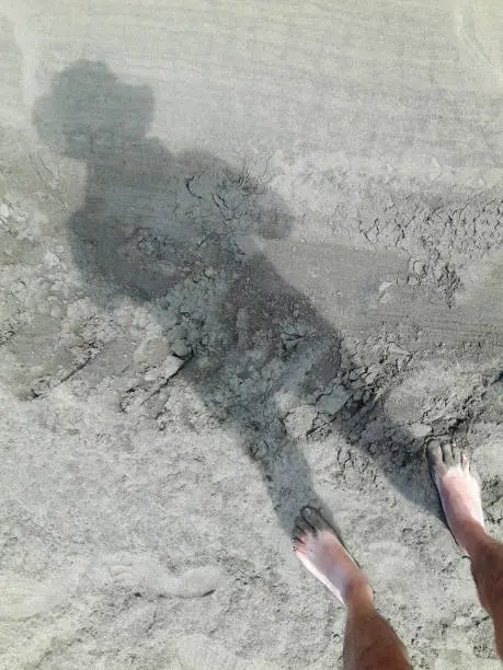 Photo of Silhouette of a Man into the sand