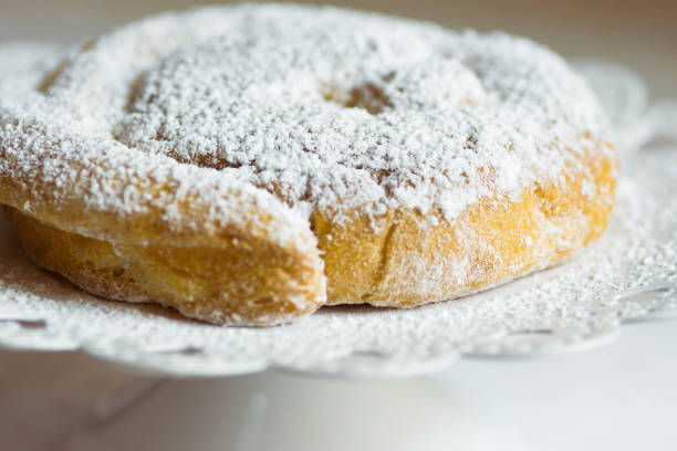 istock Fresh home baked traditional Spanish and Philippine coiled sweet bread ensaimada sprinkled with icing sugar on cake stand. Rustic style. Local cuisine specialty 1140991925