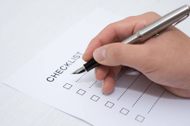 istock Close-up Of Person's Hand Marking On Checklist Form 1140993171