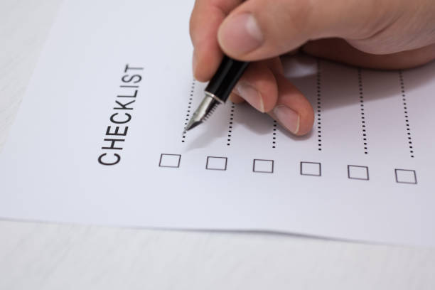 istock Close-up Of Person's Hand Marking On Checklist Form 1140993196