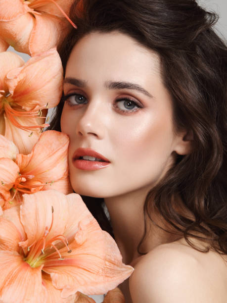 istock Beautiful young woman with flowers 1140993206
