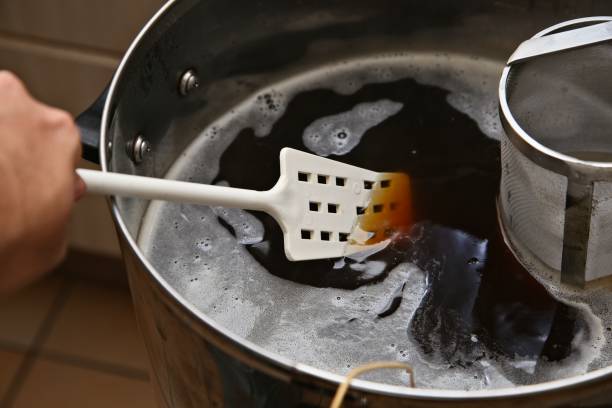 istock A man brewing craft beer in a kitchen. Home brewing concept image. 1140993725