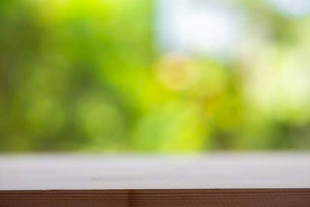 istock Empty wooden table texture, Green garden blurred bokeh background, Selective focus 1140995404