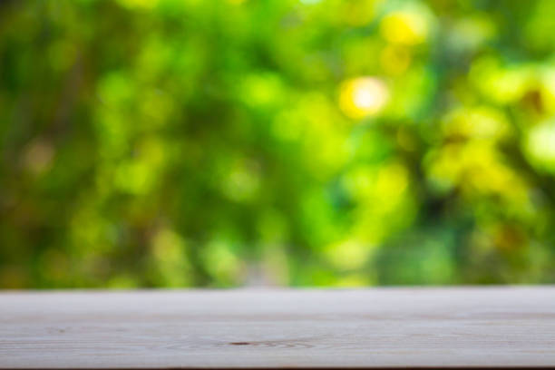 istock Empty wooden table texture, Green garden blurred bokeh background, Selective focus 1140996014