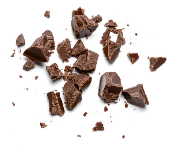 istock Dark organic chocolate pieces isolated on white background 1140996364