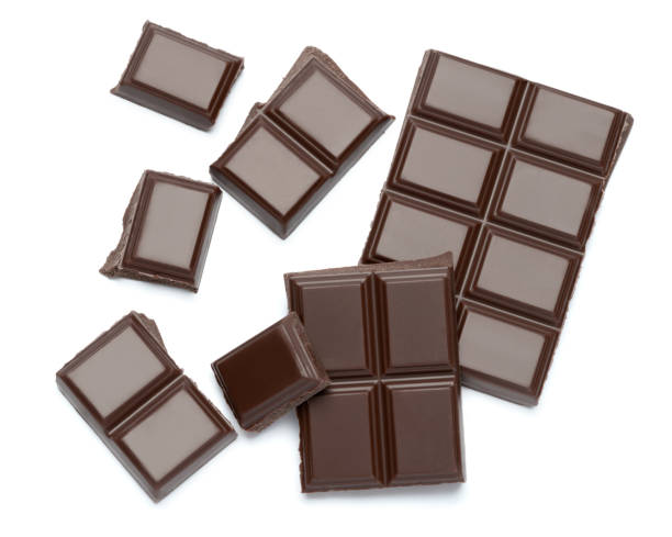 istock Dark organic chocolate pieces isolated on white background 1140996387