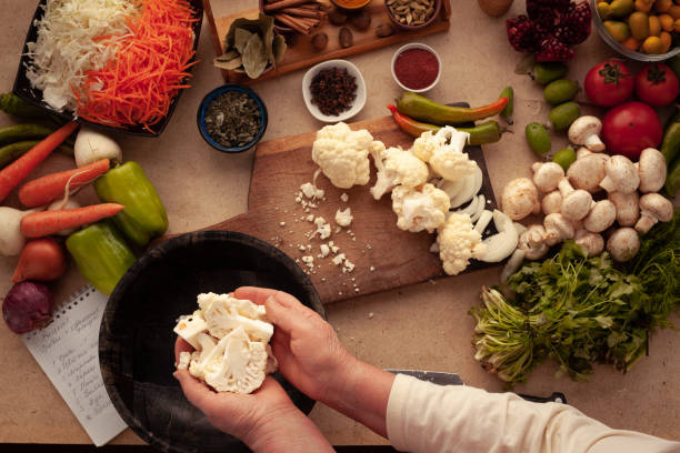 Preparing cauliflower for cooking stock photo