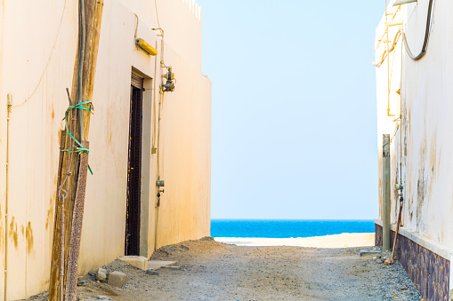 View of a narrow street of the Omani city Al Ayjah.