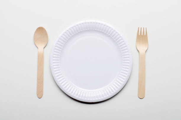istock Top view at wooden single use kitchenware and paper plate on white background 1141004106