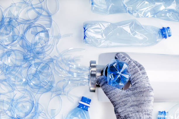 istock Plastic recycling. Recycling machine drinding plastic bottle. Ecology concept. 1141005436