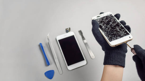 istock Technician repairing broken smartphone on desk 1141006343