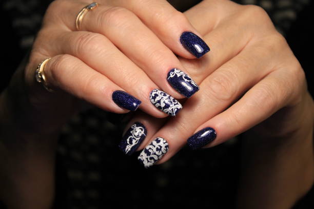 istock Beautiful woman's nails with beautiful christmas manicure 1141007587