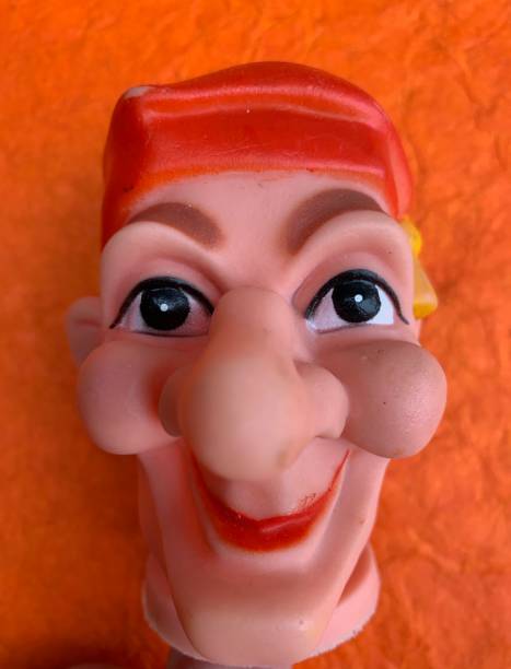 istock Finger punch puppet, clown or fool, orange background 1141007887