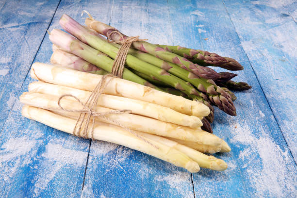 istock White and green asparagus on vintage old background. 1141008390