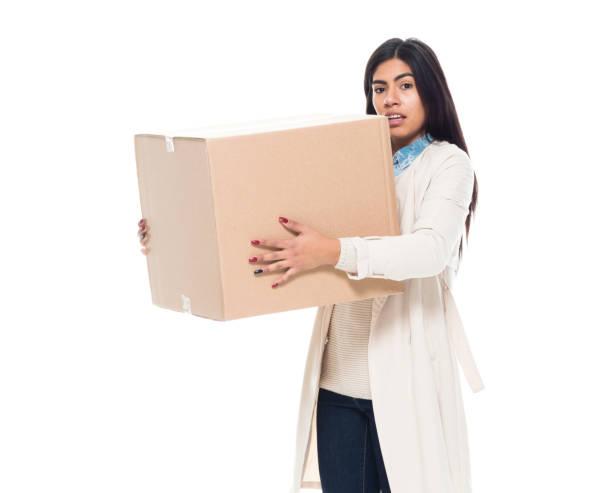 istock Attractive young latino female is holding a box 1141009347