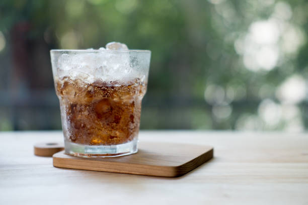 istock Cold soft drink refreshing pop flavored with ice cubes. Bubble water drops poured on glass. 1141009494