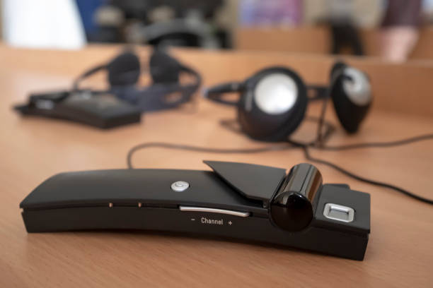 istock Wireless simultaneous translation system with headphones lies on the table during a lecture at international conference or scientific report 1141010231
