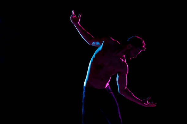 istock Sexy shirtlessman with color gel lighting 1141010411