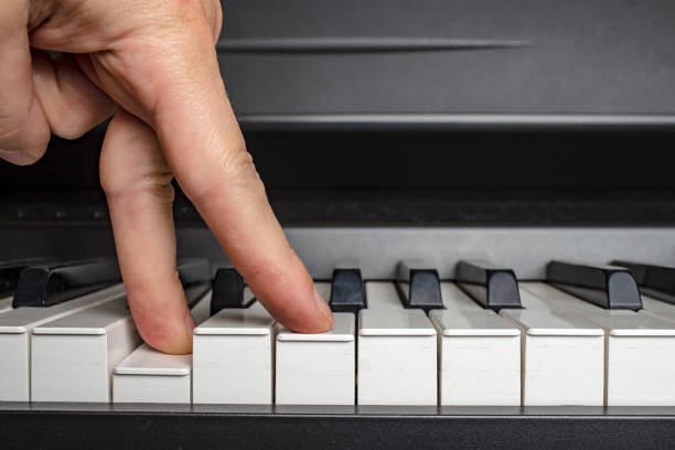 istock fingers click on the piano keys 1141011607