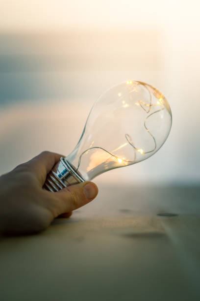 istock Time for ideas, inspiration and invention: Hands are holding a LED lightbulb. 1141011845