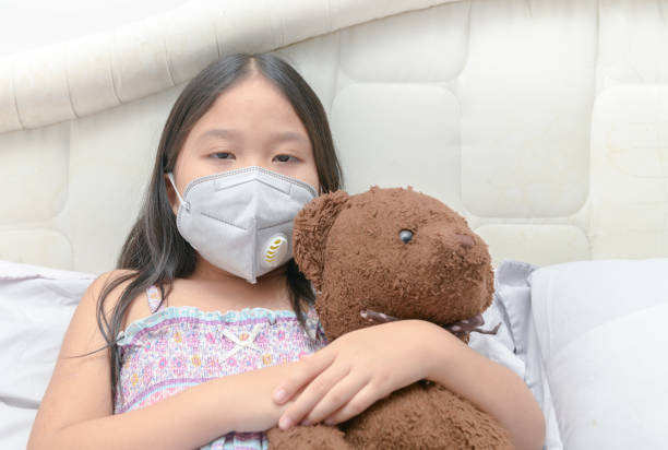 istock Asian girl wearing a dust mask PM2.5 on bed, 1141012016