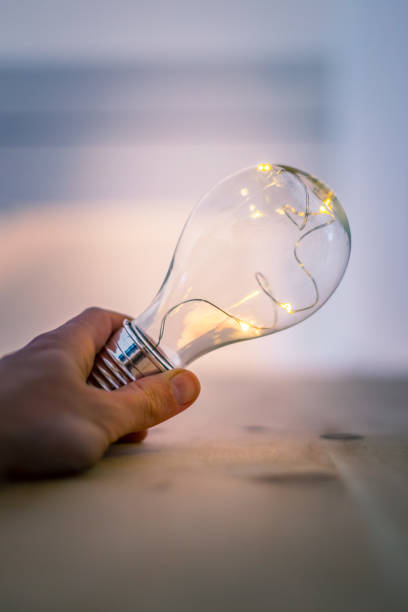 istock Time for ideas, inspiration and invention: Hands are holding a LED lightbulb. 1141012142