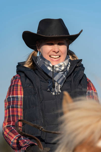 istock Woman horseback riding 1141013938