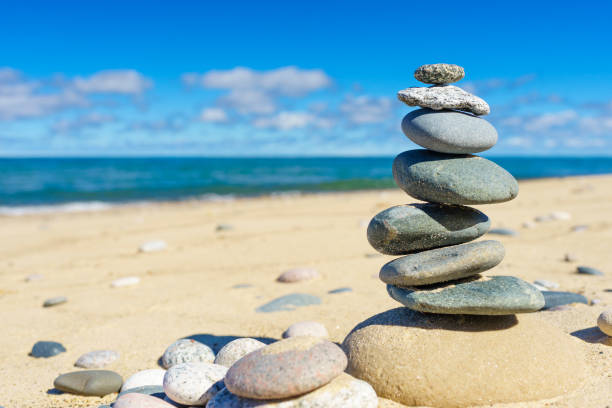 Rock Cairn A rock cairn on a sandy beach.  Rock cairns are used as trail markers in places such as this secluded shore on Lake Superior. cairn stock pictures, royalty-free photos & images