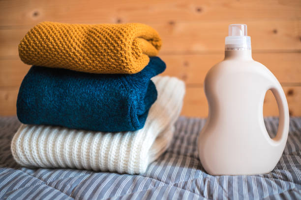 istock Bottle of detergent and a pile of sweaters. 1141016047