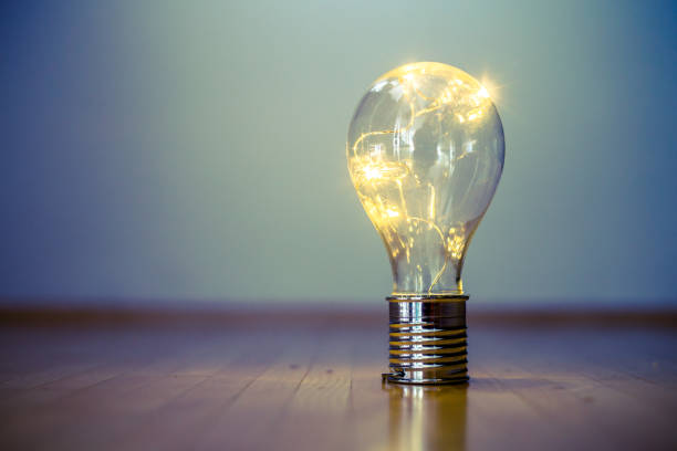 istock Ideas and innovation: Light bulb with LEDs is lying on the wooden floor. Copy space. 1141016912