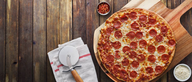 istock pepperoni pizza on wooden serving board shot top down 1141017345