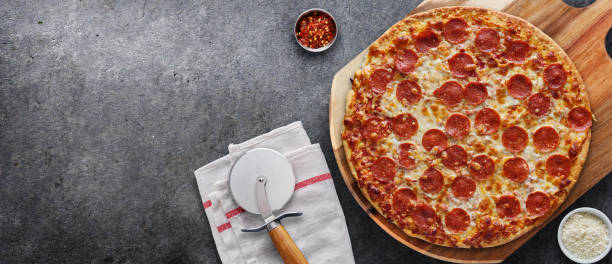 pepperoni pizza on wooden serving board