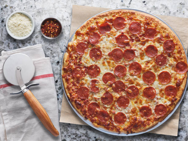 istock large pepperoni pizza on marble counter from bird's eye view 1141017412