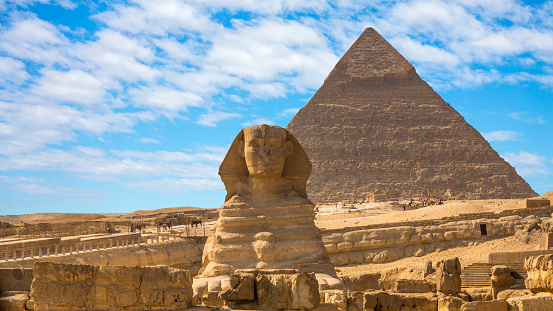 Giza pyramids and camel drivers at sunrise.