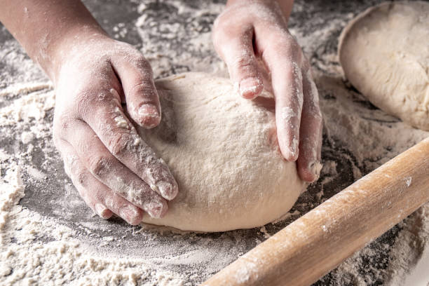 istock Making dough by female hands at bakery 1141021642