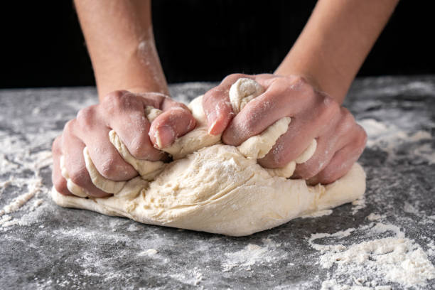 istock Making dough by female hands at bakery 1141021667